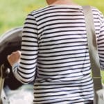 Mother walking with baby in a stroller