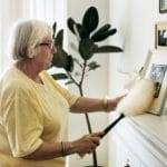 Senior woman dusting a family photo