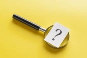 Magnifying glass with question mark on yellow